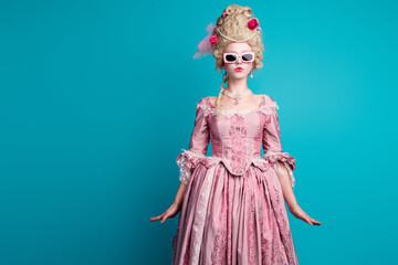 Photo of young aristocratic woman sunglass empty space wear baroque dress isolated on teal color...