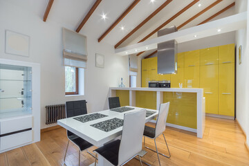 Modern interior design of the kitchen of a private house. Elegant furniture and a yellow facade of the kitchen set.