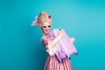 Photo of positive charming medieval lady wearing corset dress preparing for trip isolated on blue...