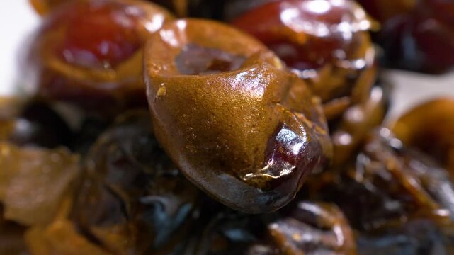Dried dates, close-up macro shot, top view. On a turntable, spinning in motion. Slow motion