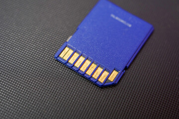 Close-up of a Micro SD memory card against the background of a microcircuit, Concept of transfering photos and videos. Selective focus.