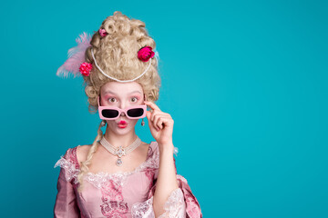 Photo of young aristocratic woman pouted lips empty space wear baroque dress isolated on teal color...