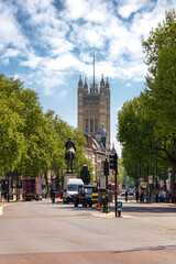 London, England, UK - May 1, 2025: Busy London Street and Victoria Tower, Palace of Westminster, London, UK.