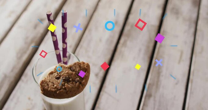 Bright geometric shapes emerging circling glass of milk and cookie clustering fading in confetti