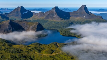 Panoramic view of a serene lake nestled among majestic, mist-shrouded mountains under a clear sky