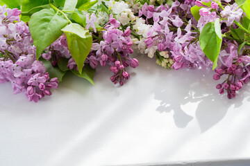 lilac branch with flowers on a white table
