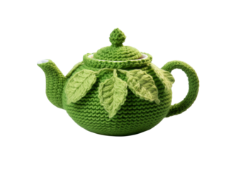 Knitted green teapot cozy with leaves isolated on a white background