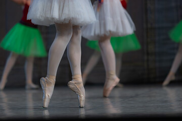 Closeup of ballerina dancing isolated on stage.