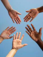 A group of outstretched hands of different skin tones reaching from different directions. Symbol of unity, diversity and collective effort. Human connection, inclusivity and collaboration concept