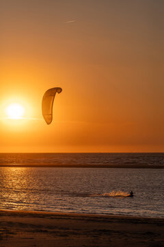 Kiter at sunset in golden light