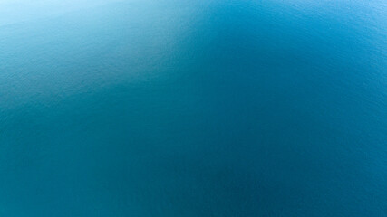 Aerial view of the surface of the blue water of the sea. Ideal for backgrounds, textures and patterns.