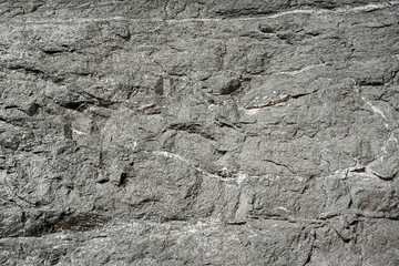 Nature grey stone wall on cave surface for abstract background and texture. Template for design, natural patterns, space for work, banner,seamless wallpaper, close up.
