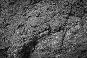 Empty grey stone wall on cave surface for abstract background and texture. Template for design, natural patterns, space for work, banner,seamless wallpaper, close up.