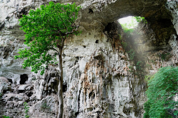 Light shines through the hole of the cave at Tham Than Lot Yai, Chaloem Rattanakosin National Park, Kanchanaburi Province,Thailand.