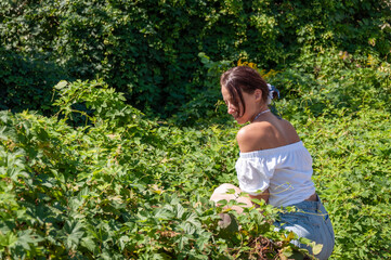 Woman sitting in lush green forest. Organic clothing. Rural lifestyle. Nature retreat lifestyle....