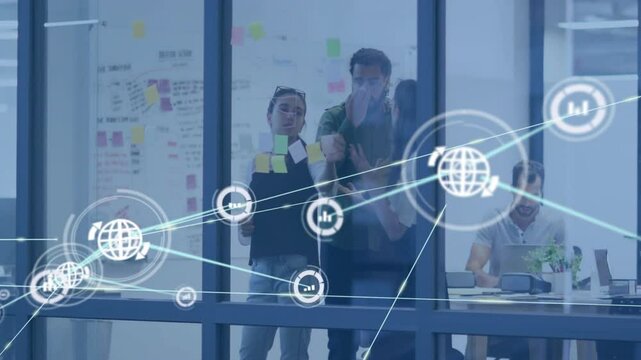 Team placing sticky notes on glass wall, finalizing plan and spawning animated data network overlay