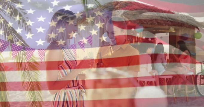 Flag pattern dissolving revealing travel couple on beach holding bottles and toasting for fun