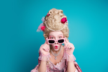 Photo of young aristocratic woman touch sunglass stare wear baroque dress isolated on teal color...