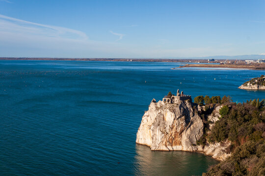 Duino, Italy - January 11, 2025: The old castle of Duino, now in ruins, overlooks the sea.
