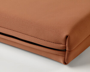Brown leather case corner showing zipper detail