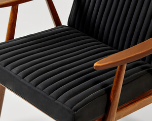 Modern lounge chair with black upholstery and wooden frame displaying comfort and style