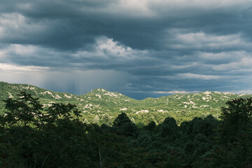 Incredible mountain landscape with mysterious dark sky before rain