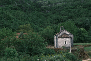 An old stone church in a secluded location in a stunning mountain landscape