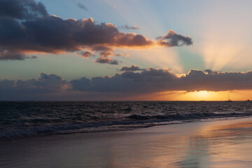 A calming ocean scene during sunset with vibrant sun rays