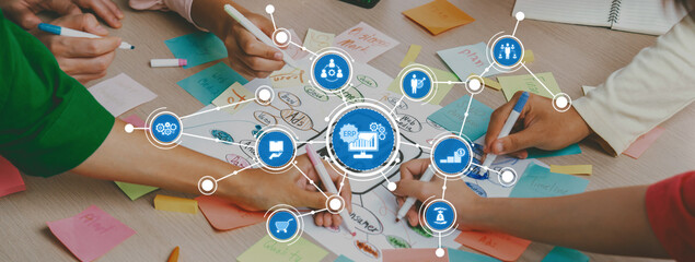 Professional startup group share creative marketing idea by using mind map. Young skilled business people brainstorm business plan while writing sticky notes. Focus on hand. Closeup. Variegated. Amity