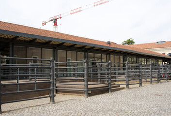 Modern architectural structure featuring large glass windows and wooden elements, surrounded by...