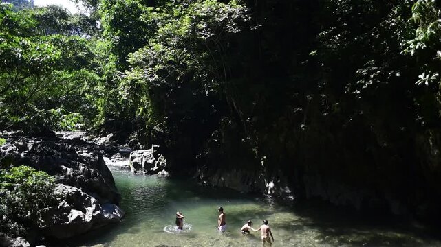 Mountain river with blue water. Wild nature landscape and grey rocks,children playing jungle tingo maria peru