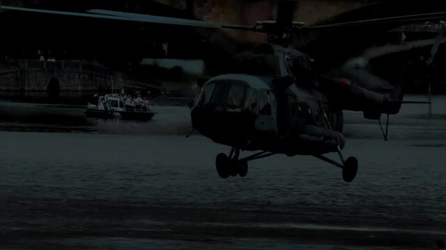Military helicopter hovers over water, soldier fast-roping during night operation, tactical training, special forces descent, army rescue mission, cinematic 4K B-roll footage 