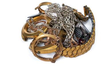 A scrap of gold. Old and broken jewelry, coins, watches of silver and gold and gold-plated on a white background.
