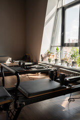Modern Pilates studio with reformer beds bright, spacious windows for exercise and wellbeing