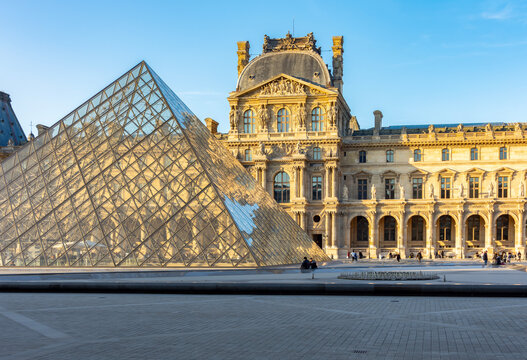 Louvre palace and pyramid in Napoleon courtyard, Paris, France