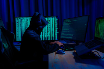 Hacker working in a dark room, deeply focused on hacking activities, surrounded by glowing screens...