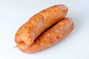 Three raw smoked sausages on white background in studio lighting for food packaging, advertising, and culinary use