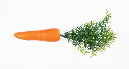 artificial plastic carrot isolated on white background
