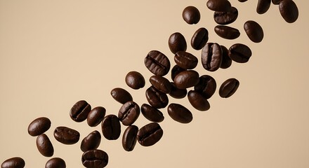 Obraz premium Roasted coffee beans flying on beige background