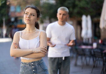 Young girl squabble with partner about jealousy. Husband and wife quarrel during walk, make...