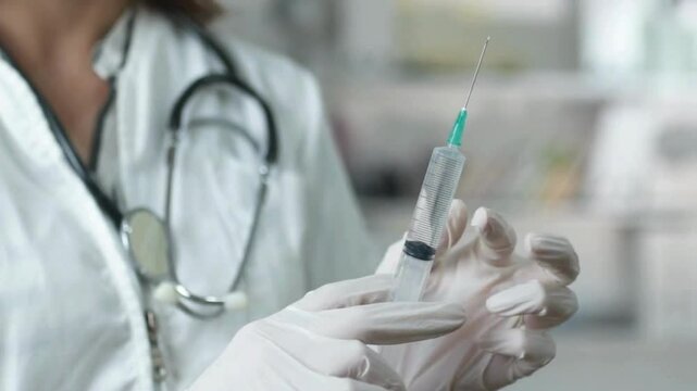 vaccine clinic Medicine and vaccination doctor preparing syringe for injection - Powered by Adobe