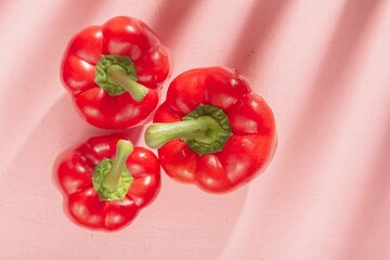 Raw sweet pepper for cooking. Abstract food texture on pink background