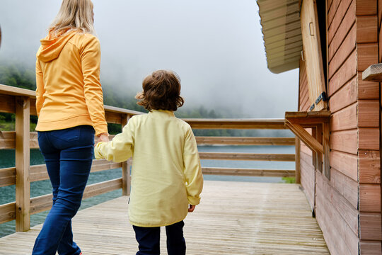 Mother with son walking on terrace