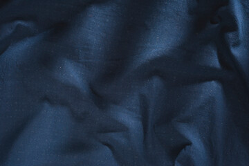 Abstract structure- wrinkles on the fabric. Textile-  simple dark background