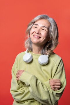 Asian senior woman smiling with headphones