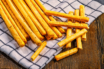 Breadsticks with sesame on rustic napkin