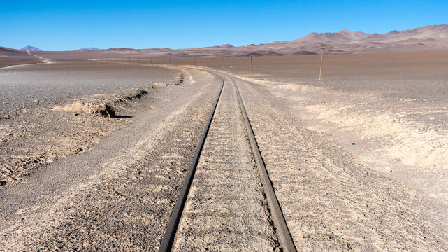 Railroad tracks through the barren landscape of La Puna, Argentina