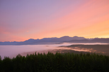 Beautiful sunrise and sunset over peaceful water and mountains