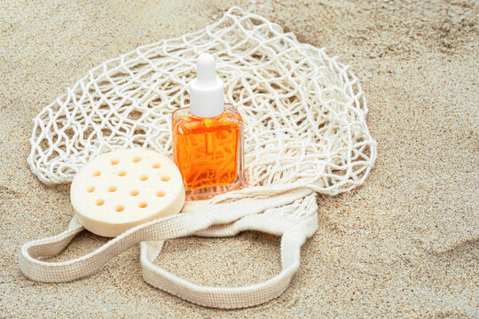 Hair care items on sand with top view perspective