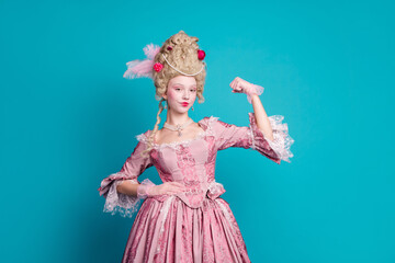 Photo of charming lovely lady wearing queen costume medieval corset dress showing strong arm isolated on blue color background